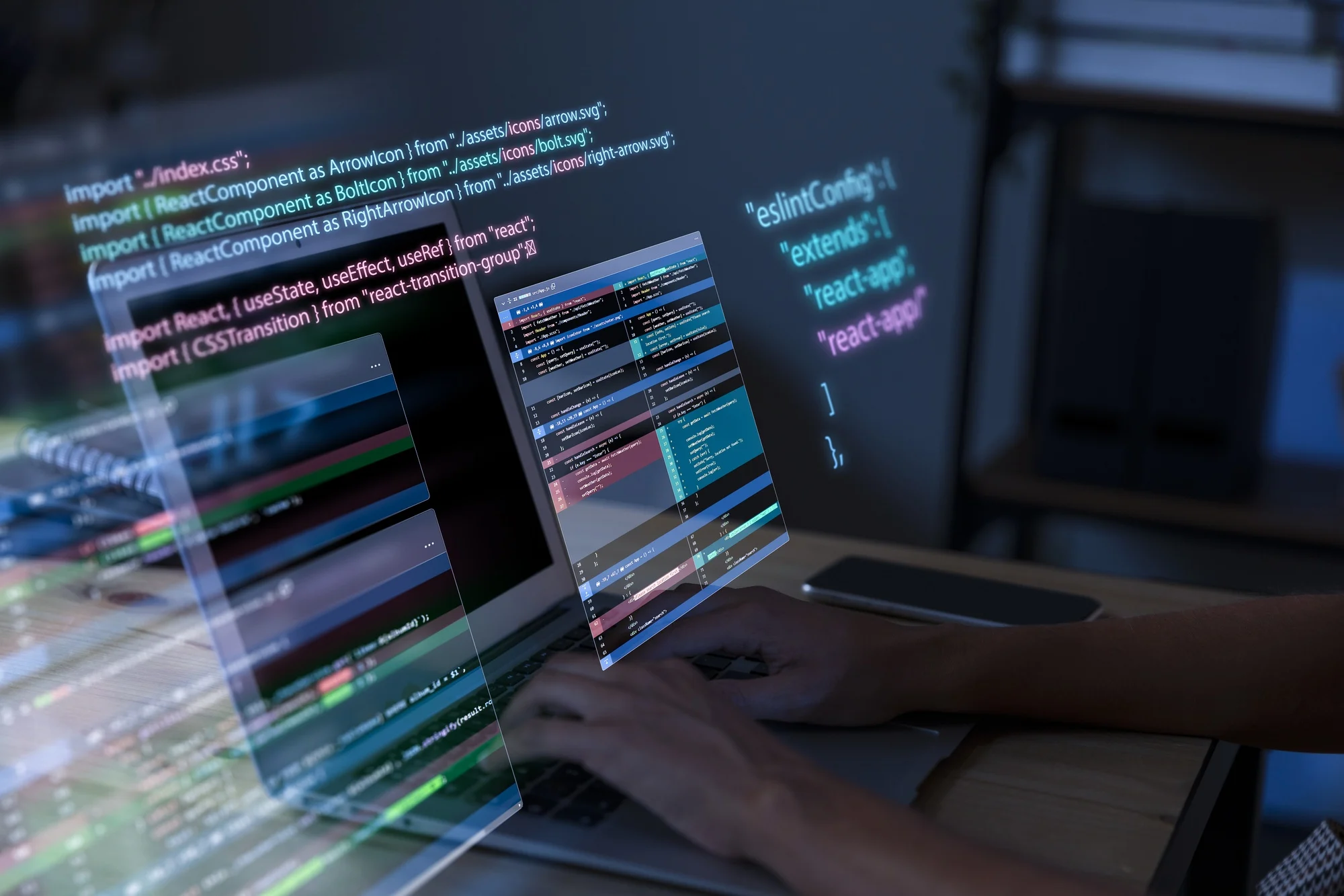 Persoon typt op laptop met een programmeercode in React op het scherm in een donkere kantooromgeving